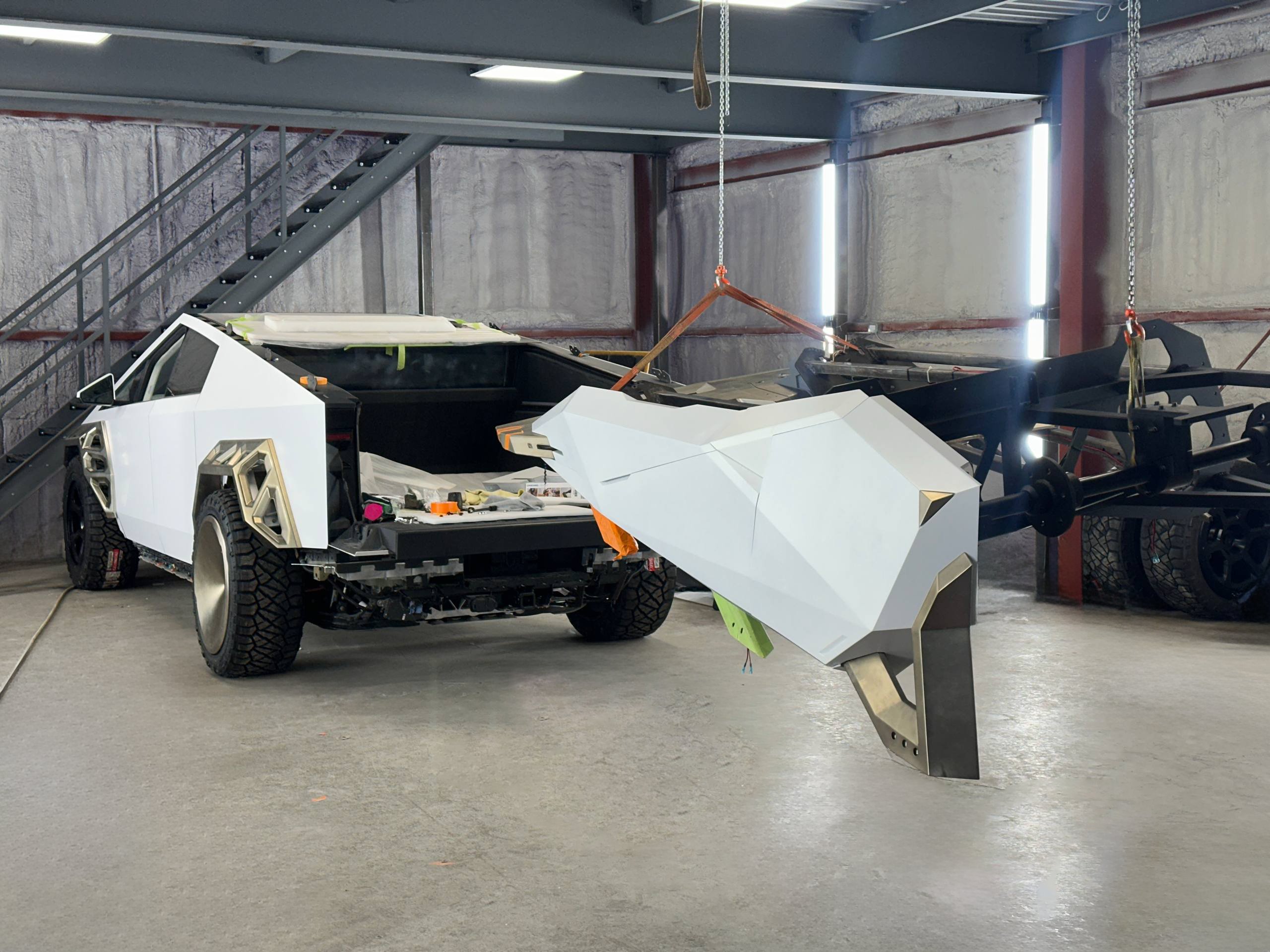 Xolaris fabrication — OEM panels set aside during new-bodywork installation