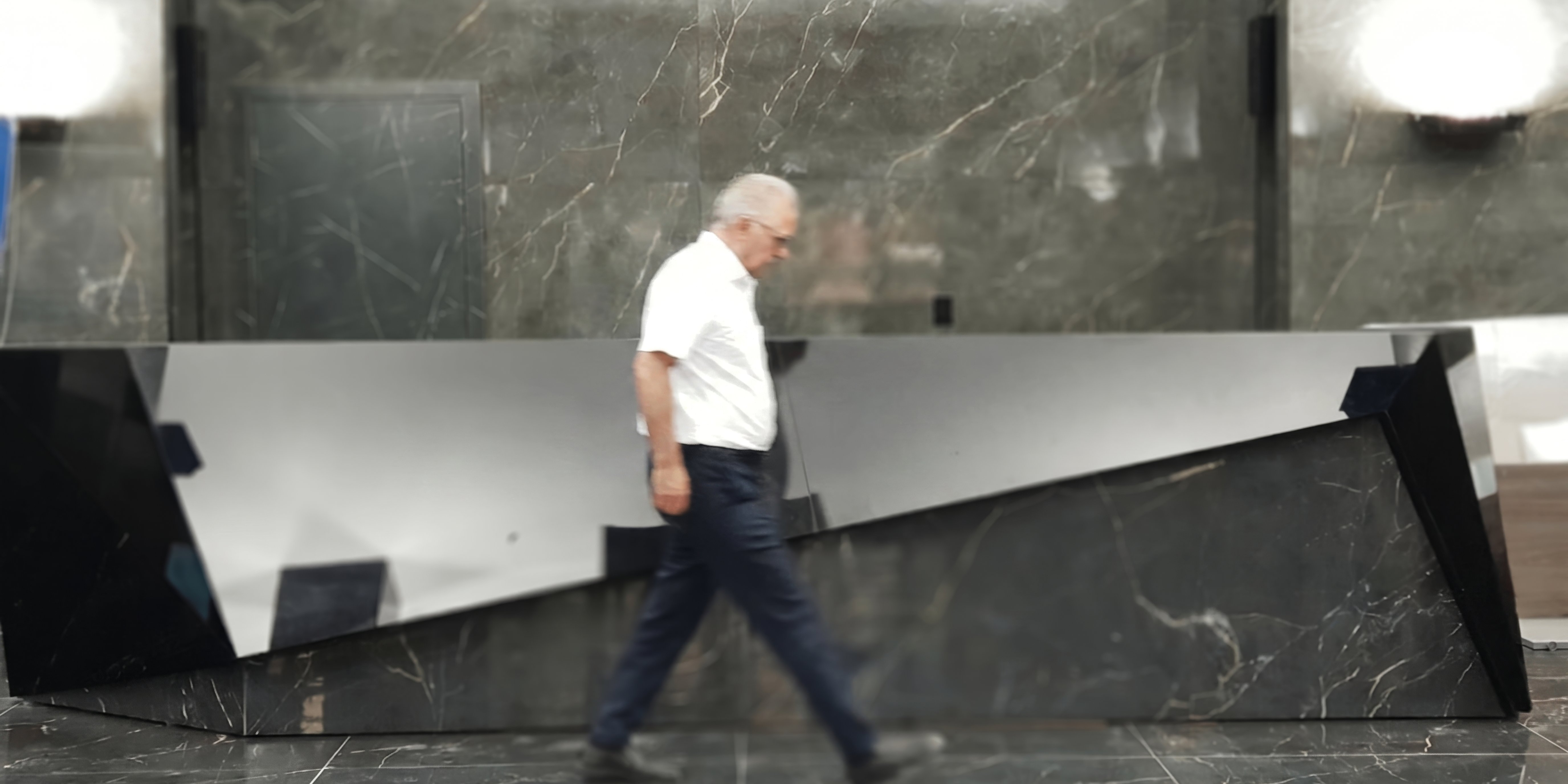 Prisma Noir in Tehran lobby — passerby for scale